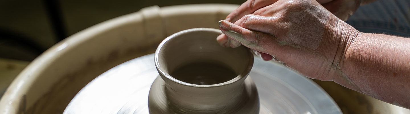 Student Sculpts a Vase on a Spinning Wheel